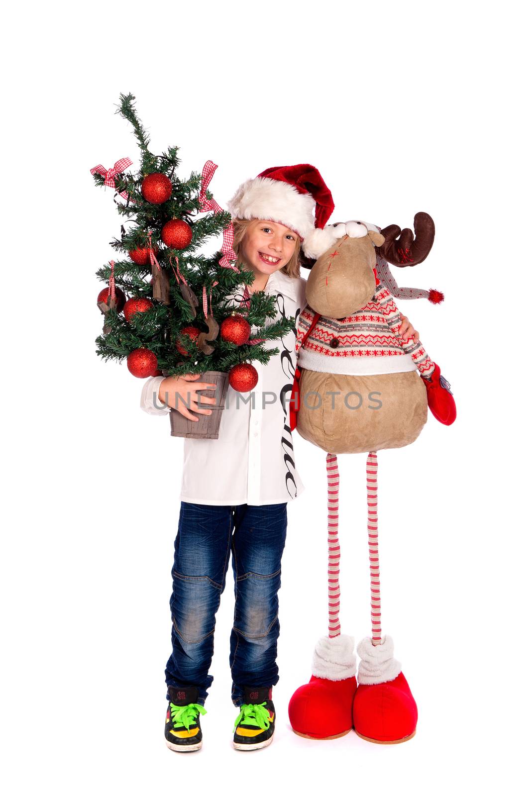 a boy with Rudolph and a christmas tree on a white background