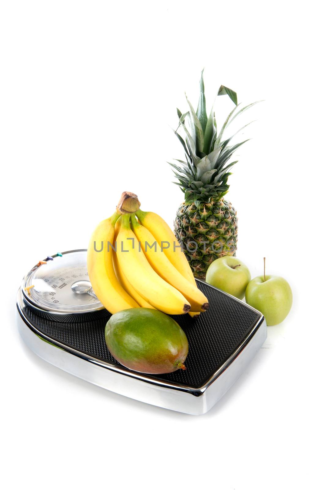 a weighing scale with fruits on a white background