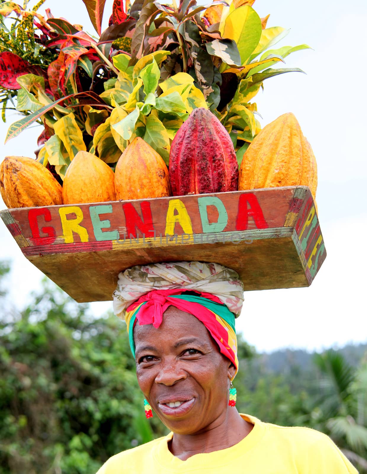 Caribbean woman posing for tourist outdoors.