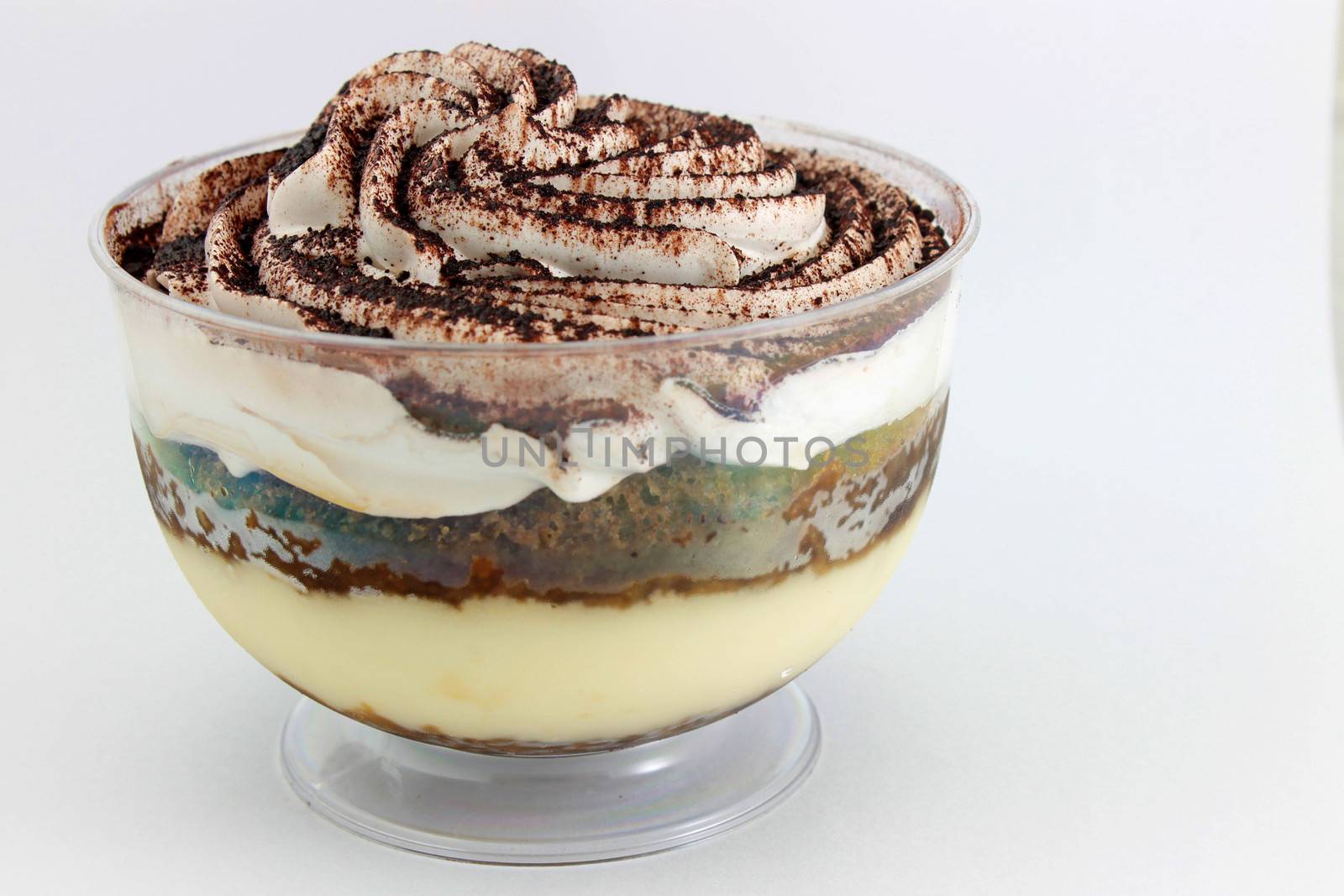 Tiramisu served in a glass on white background