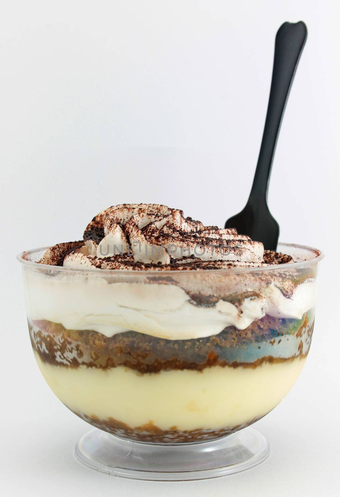 Tiramisu served in a glass on white background
