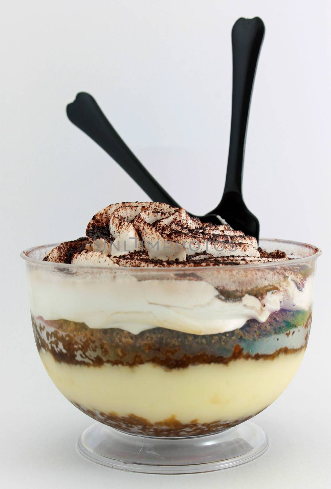 Tiramisu served in a glass on white background