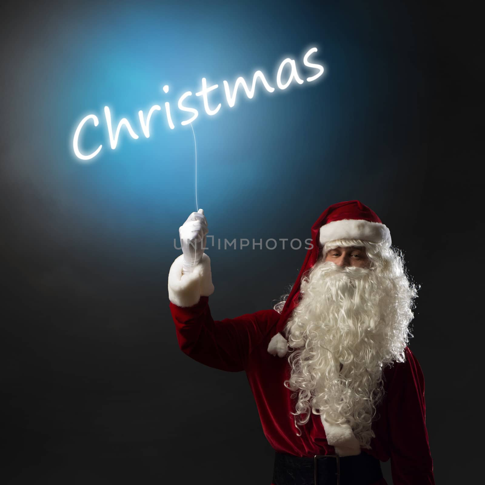 Santa Claus holding a light christmas word by adam121