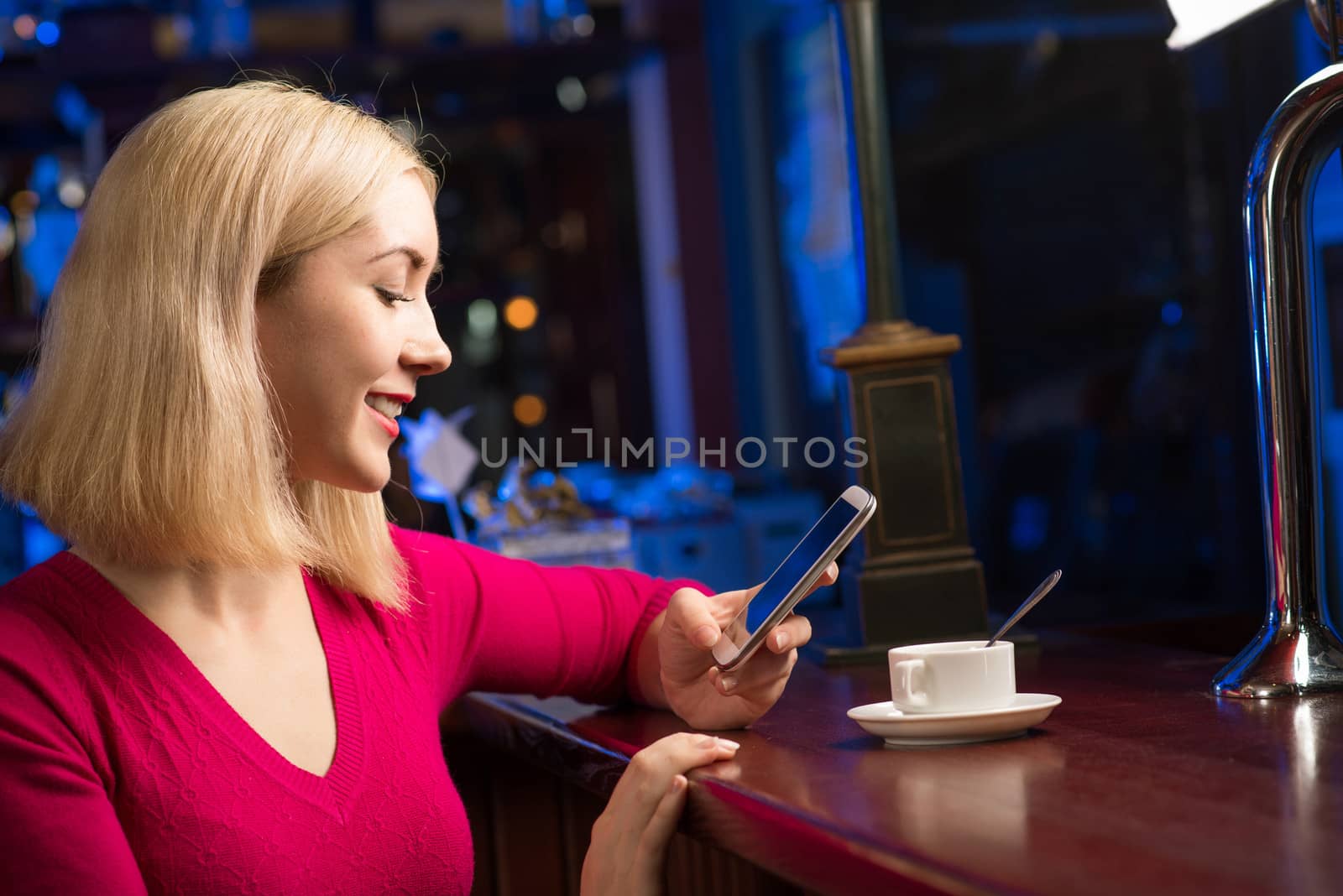 woman with a cup of coffee and cell phone by adam121
