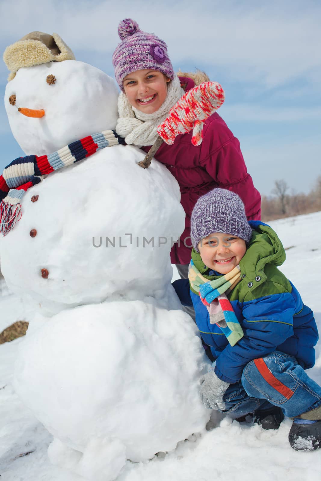 Kids make a snowman by maxoliki