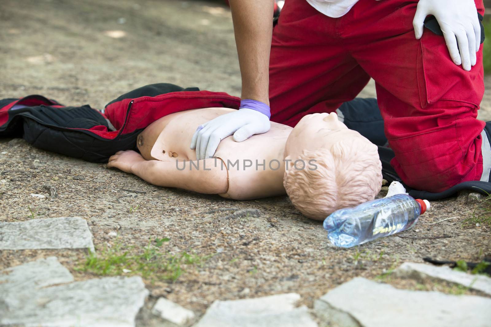 Paramedic demonstrates CPR on dummy