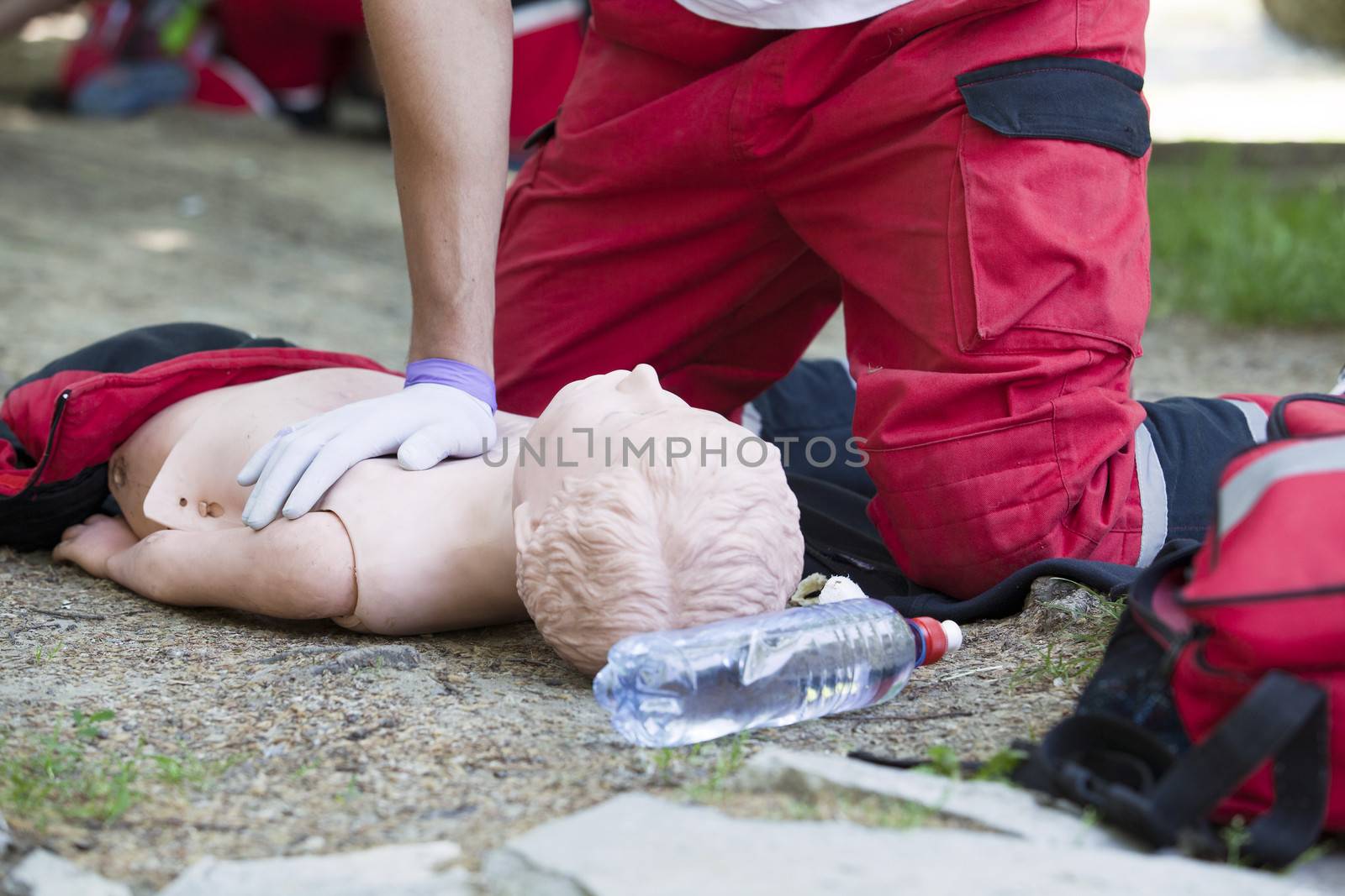 Paramedic demonstrates CPR on dummy