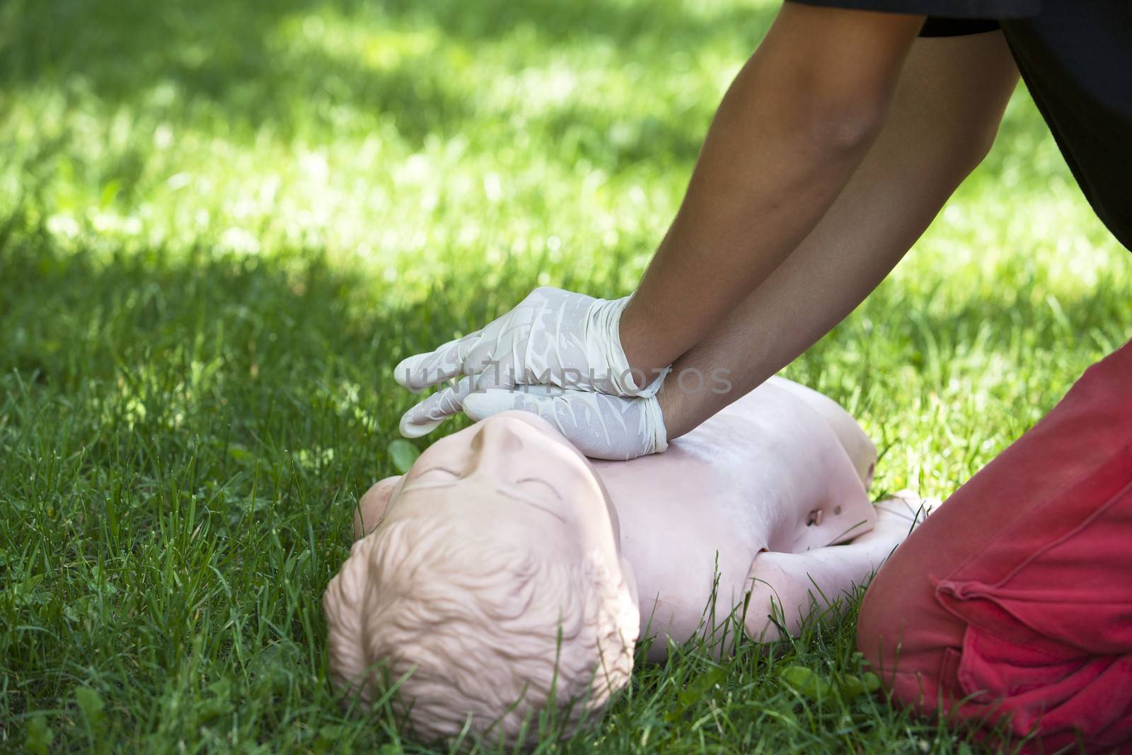 Paramedic demonstrates CPR on dummy