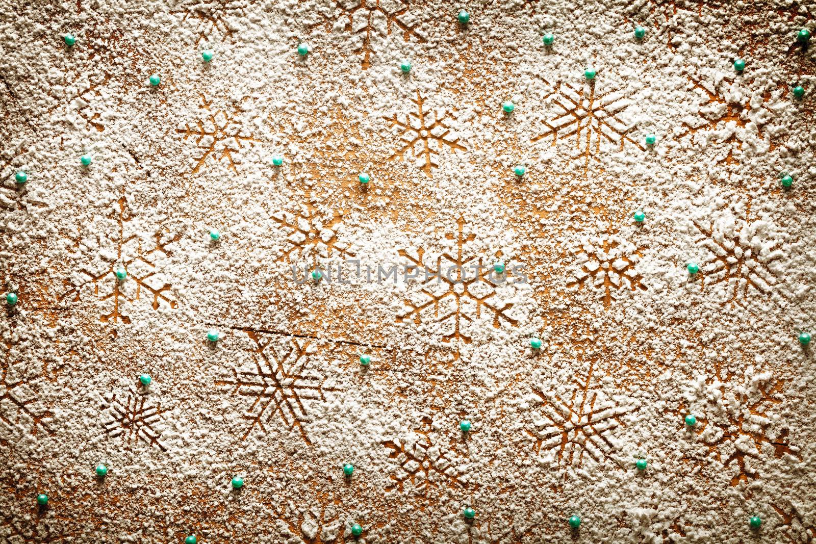 Christmas background with snowflakes for winter. Snowflake pattern made of icing sugar on wooden table. Top view