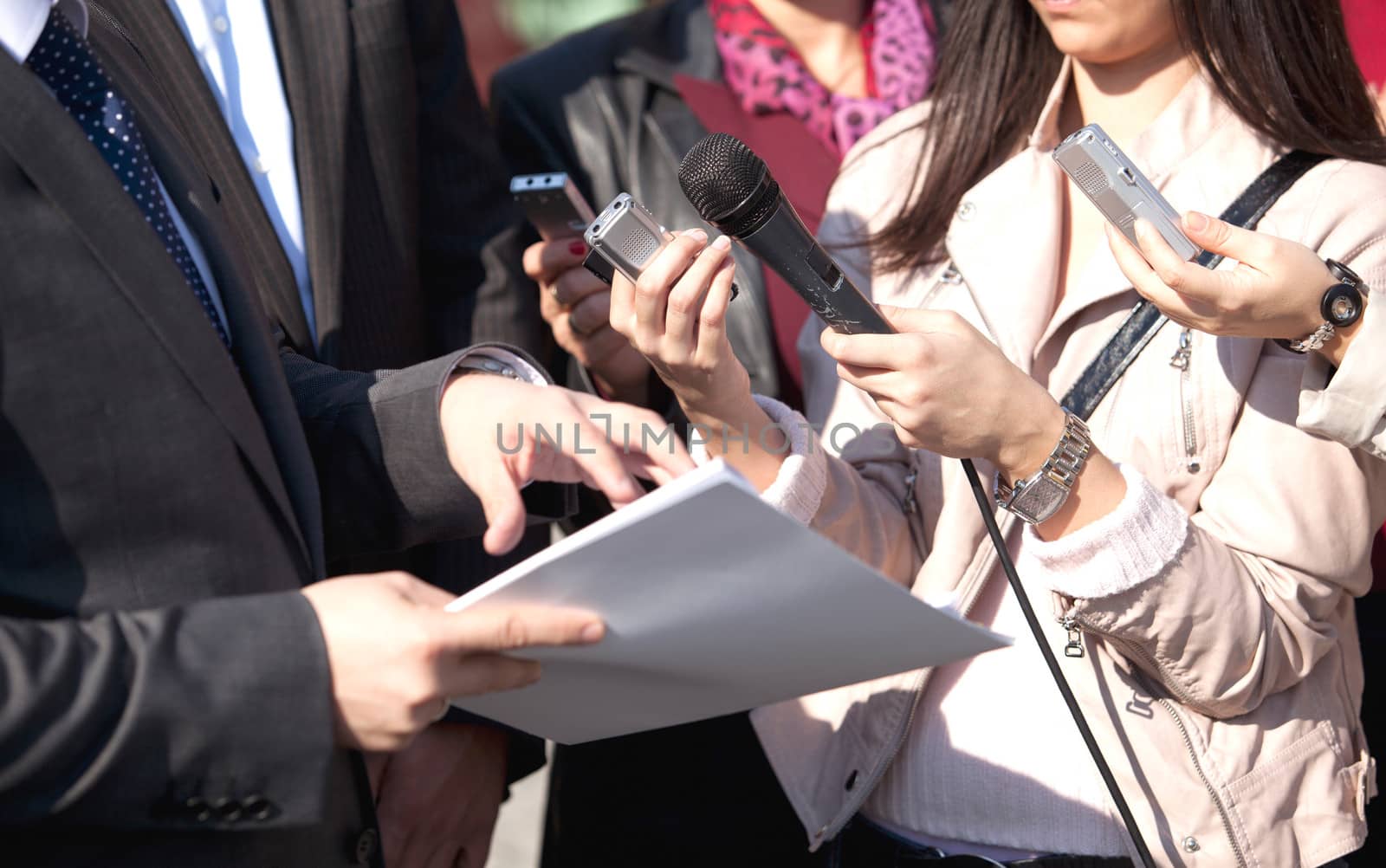 A journalist is making a interview with a microphone