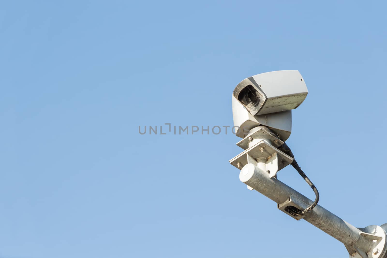 Security camera isolated on blue sky