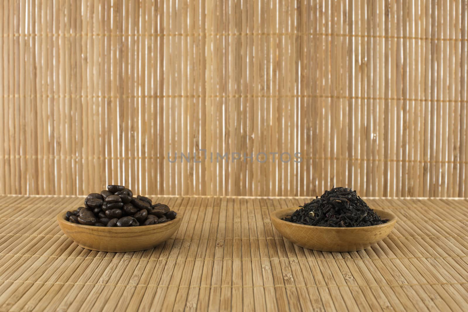 coffee beans and  tea leaves on bamboo table