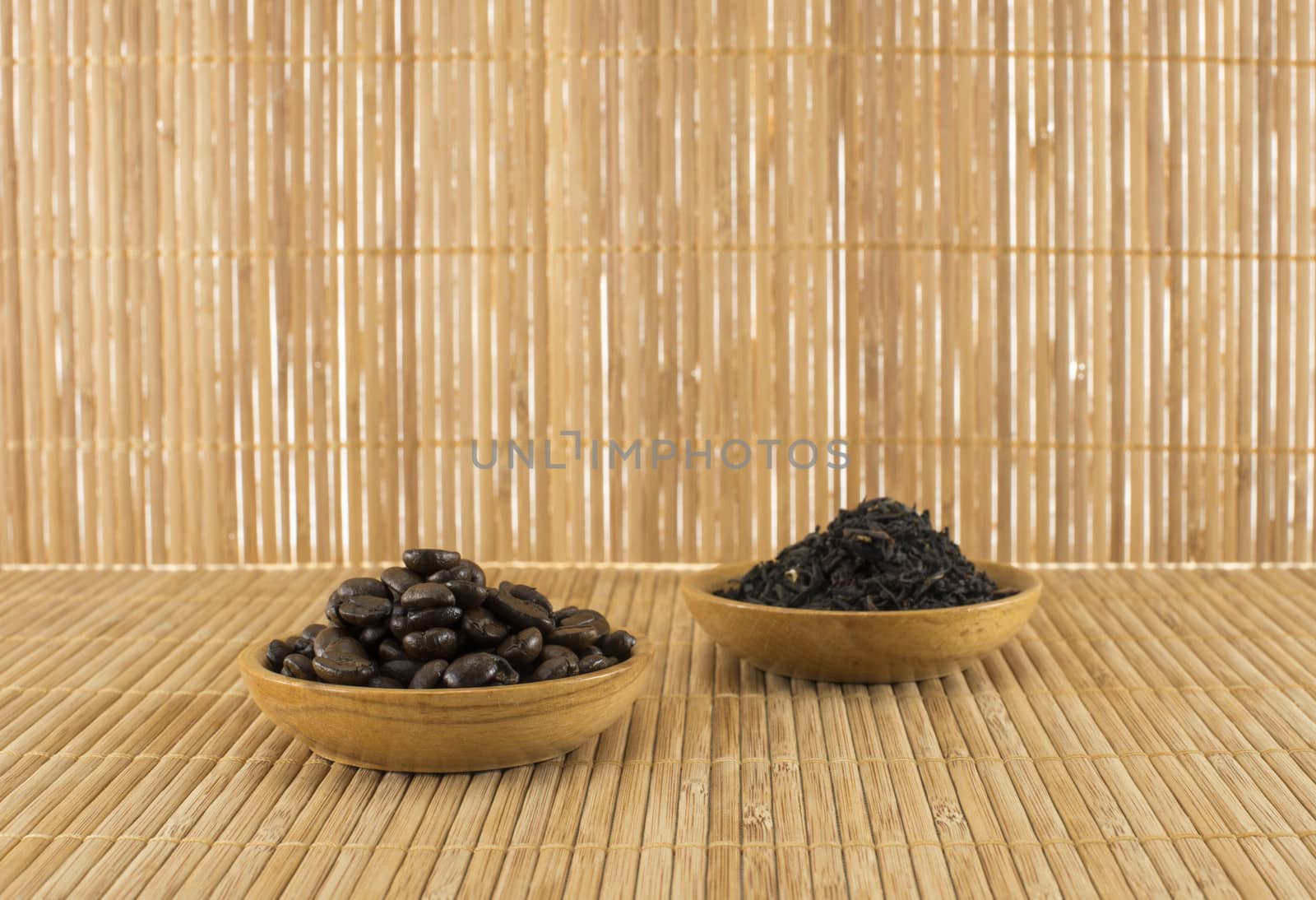 coffee beans and  tea leaves on bamboo table