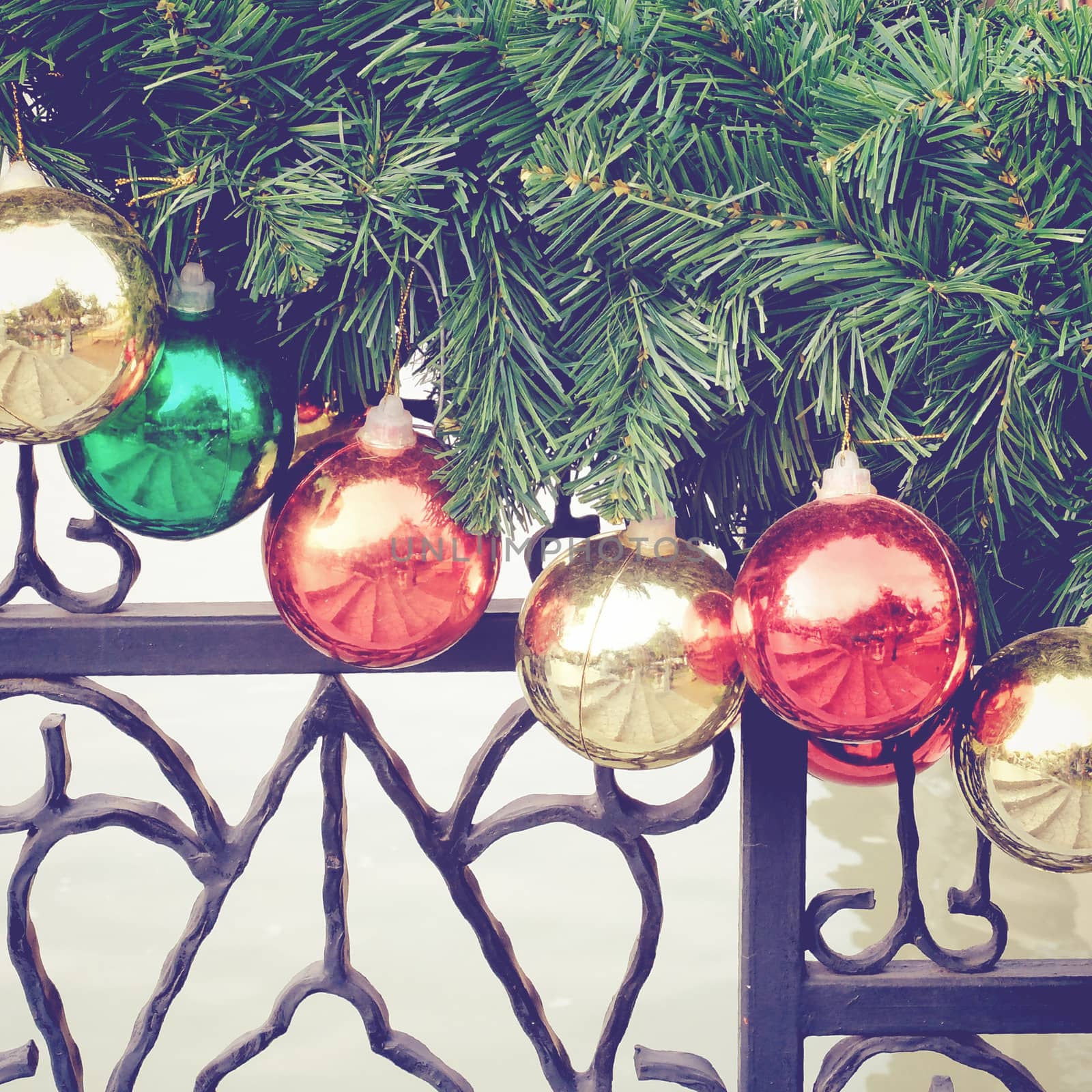 Christmas balls hanging on fir tree with retro filter effect