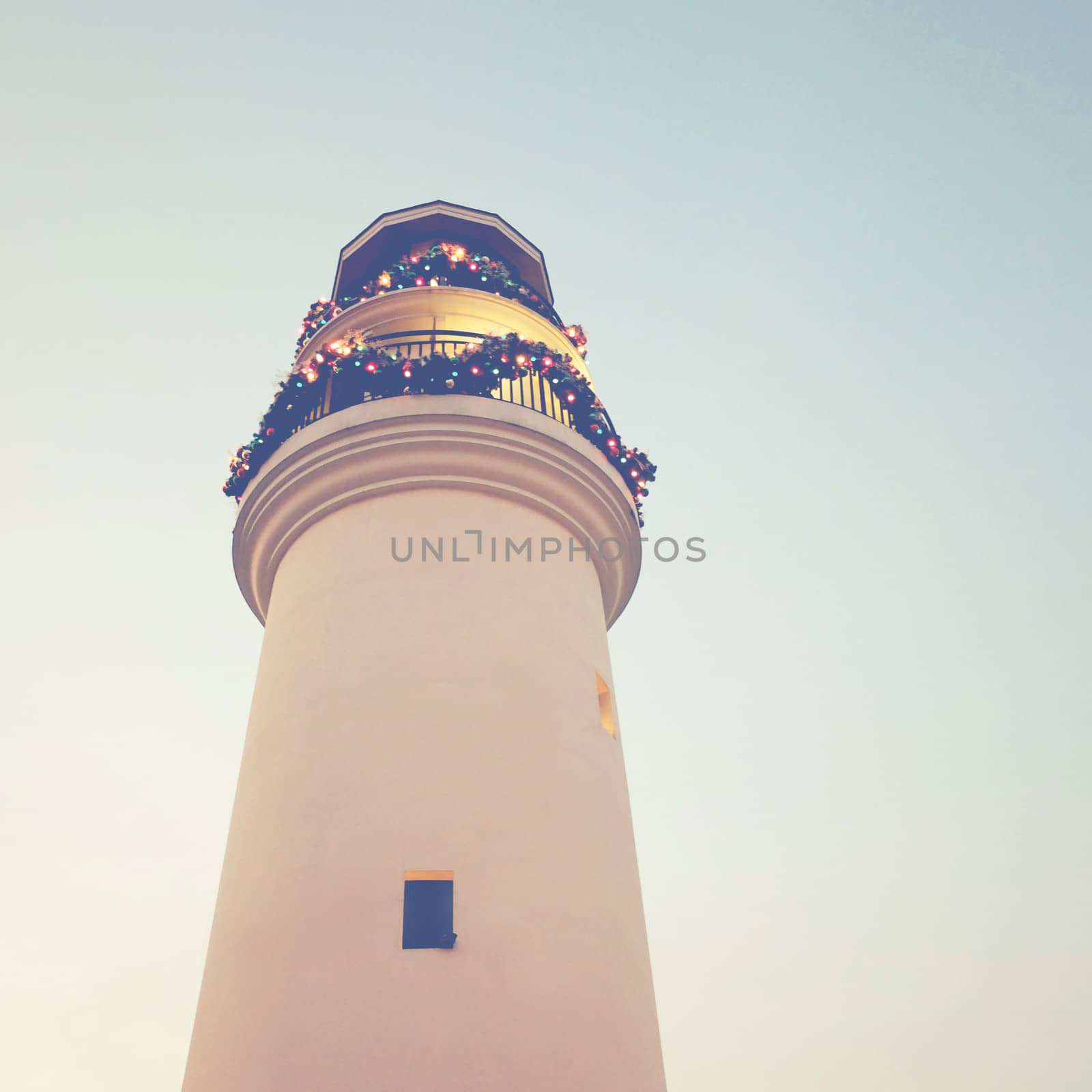 Lighthouse with christmas ornaments, retro filter effect  by nuchylee