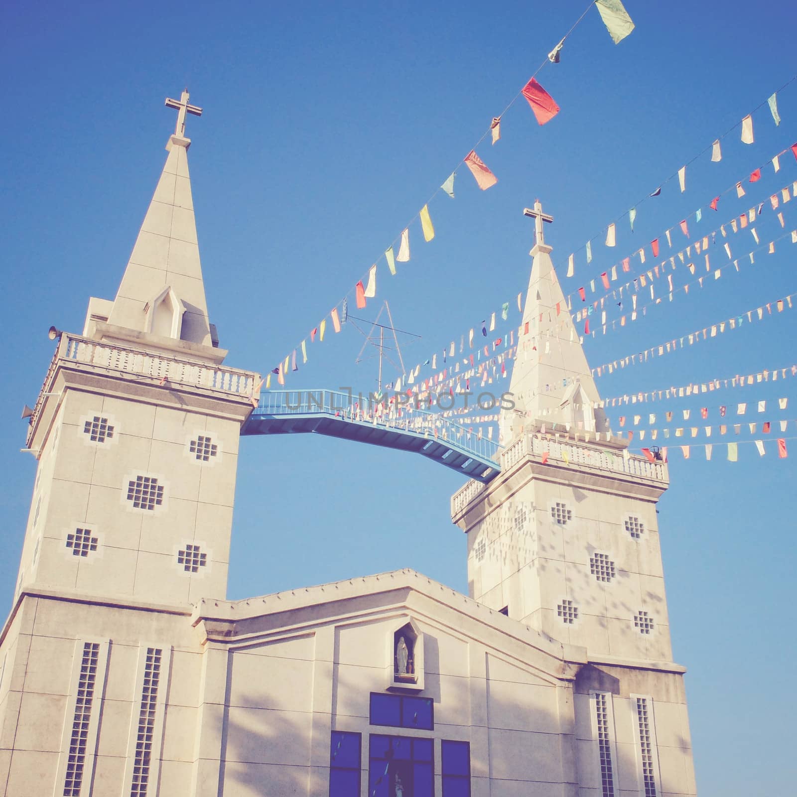 Colorful flags with a church, retro filter effect  by nuchylee
