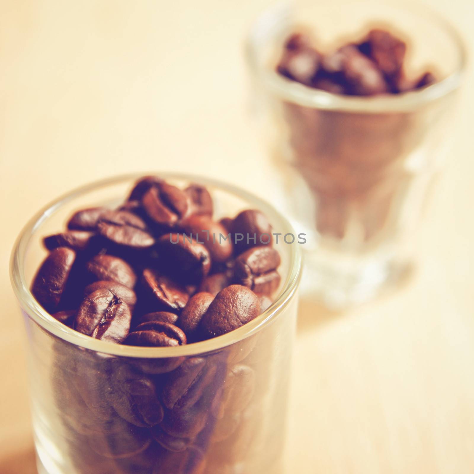 Coffee beans in glasses with retro filter effect by nuchylee