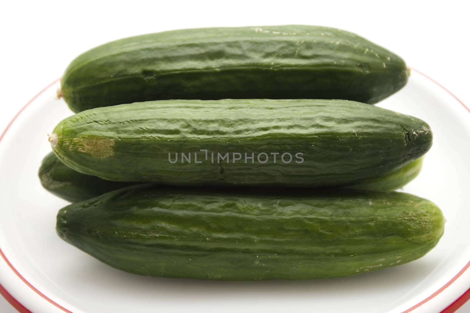 Fresh Green Cucumber on Plastic Plate