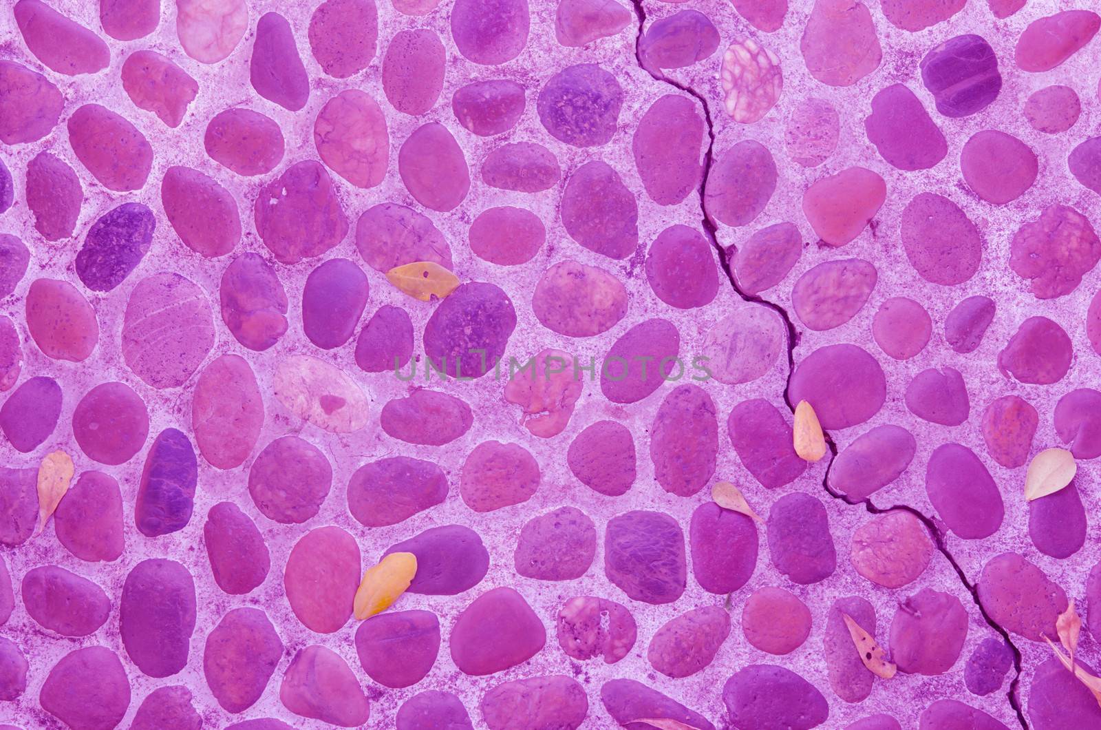 The decorative stone wall  with crack  ,  purple background texture