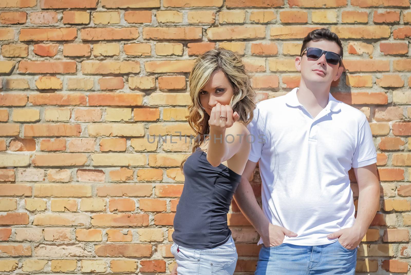 Couple portrait in front of brick wall by doble.d