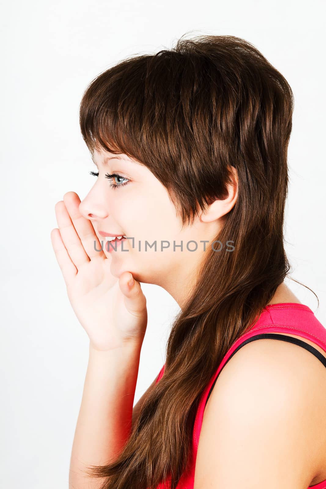 Young attractive girl whispering with hand to his lips