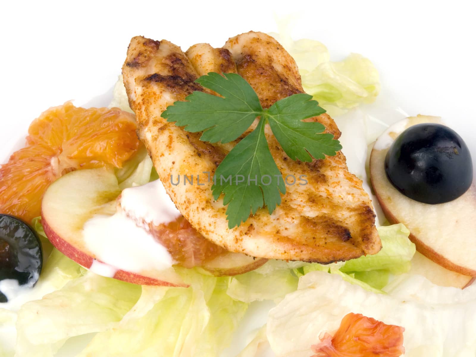Grilled chicken breast with salad and low fat yogurt dressing on white plate