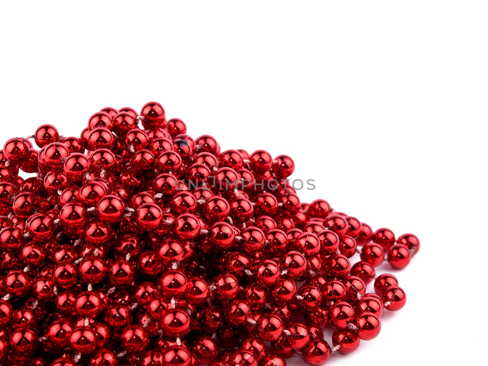 Christmas garland made from small red beads, on white background.