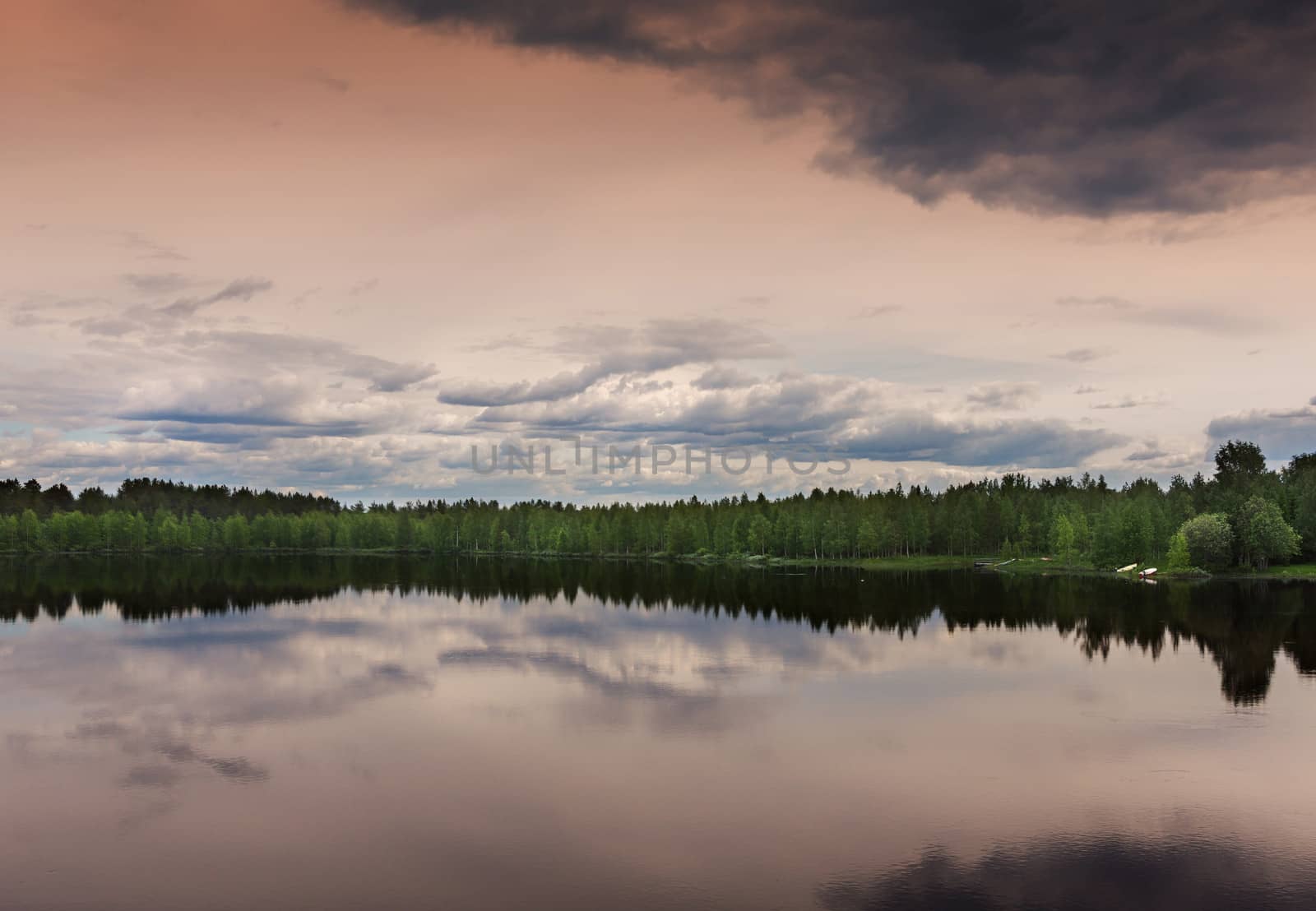 Southwest Lapland in Finland: midsummer evening over the lake. by Claudine