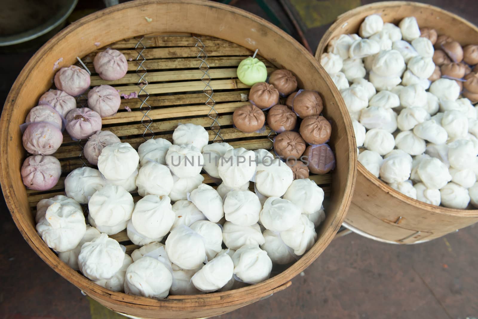 Chinese steamed buns in traditional bamboo steamer