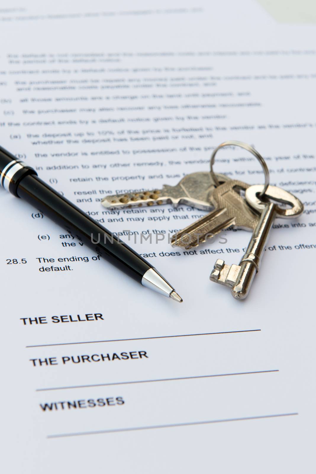 Real estate contract with pen and keys