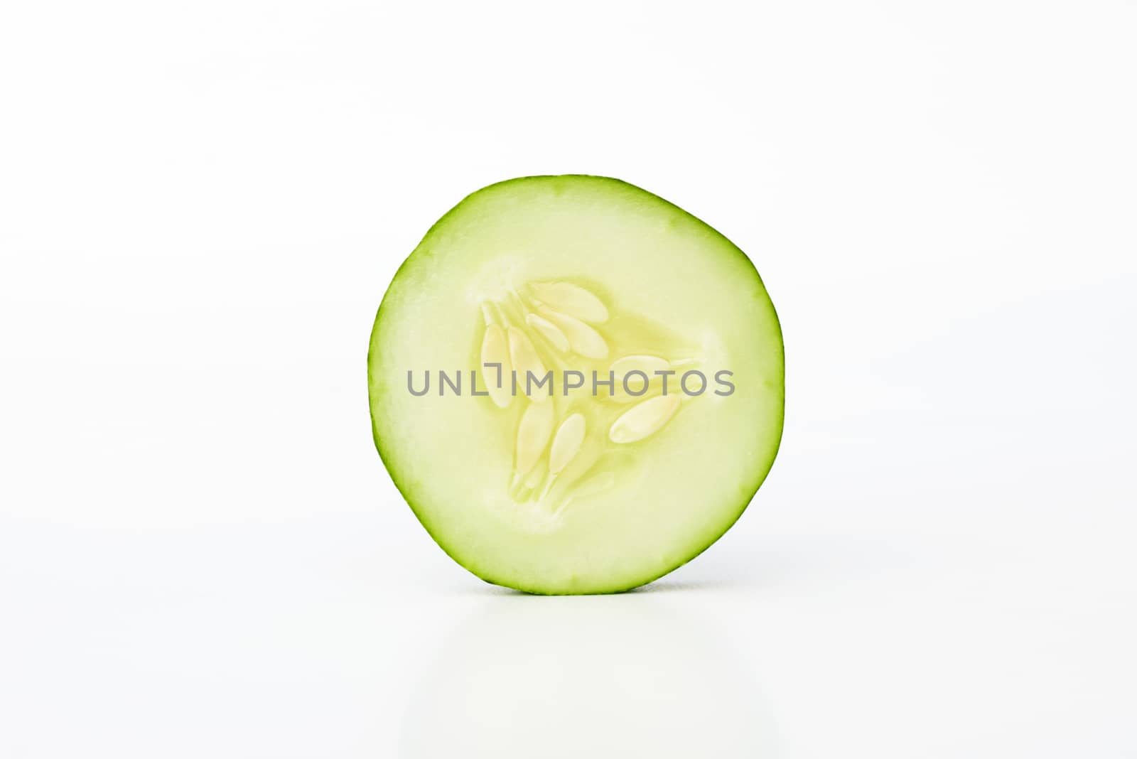 Single sliced cucumber isolated on white background
