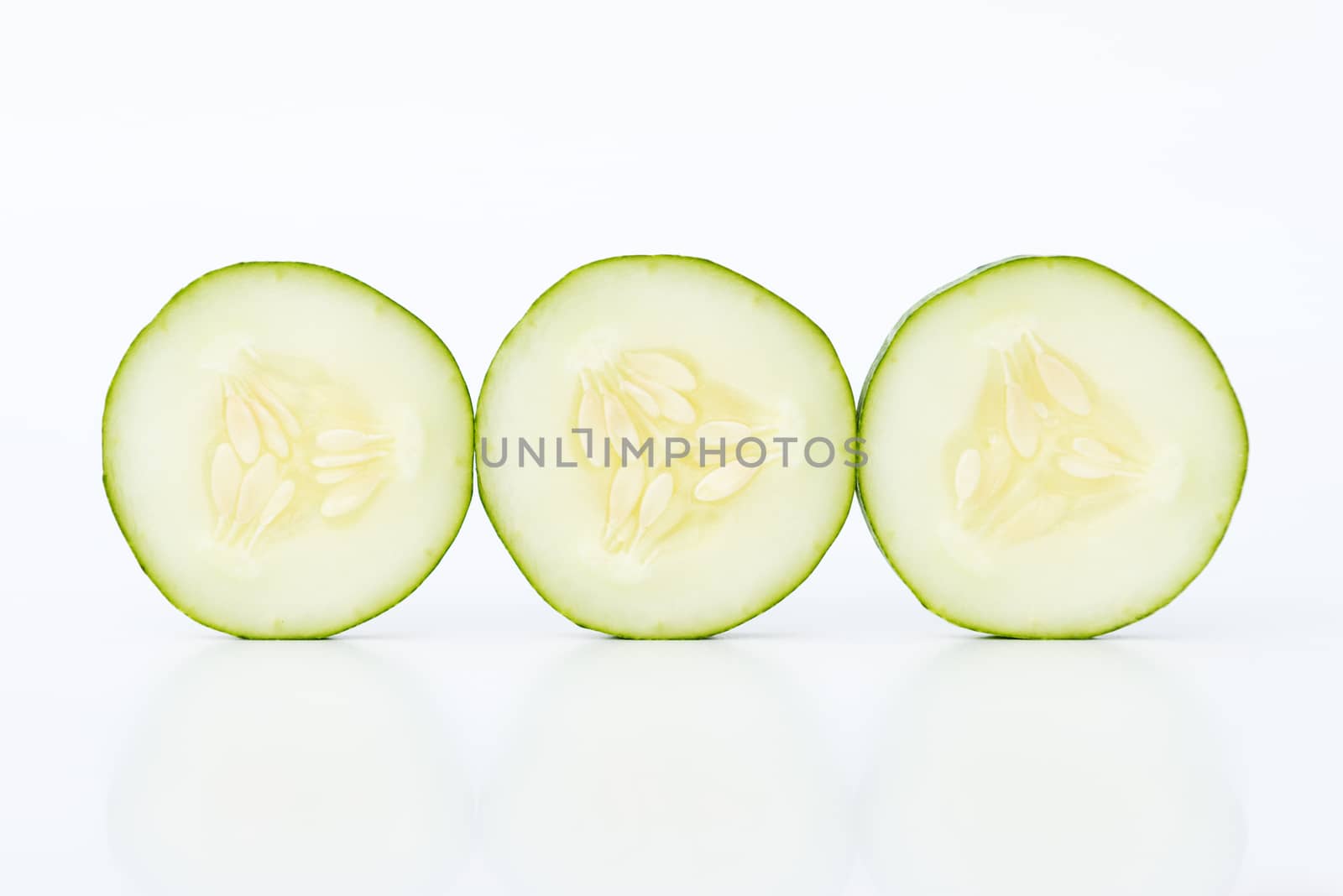 Three cucumber slices isolated on white background