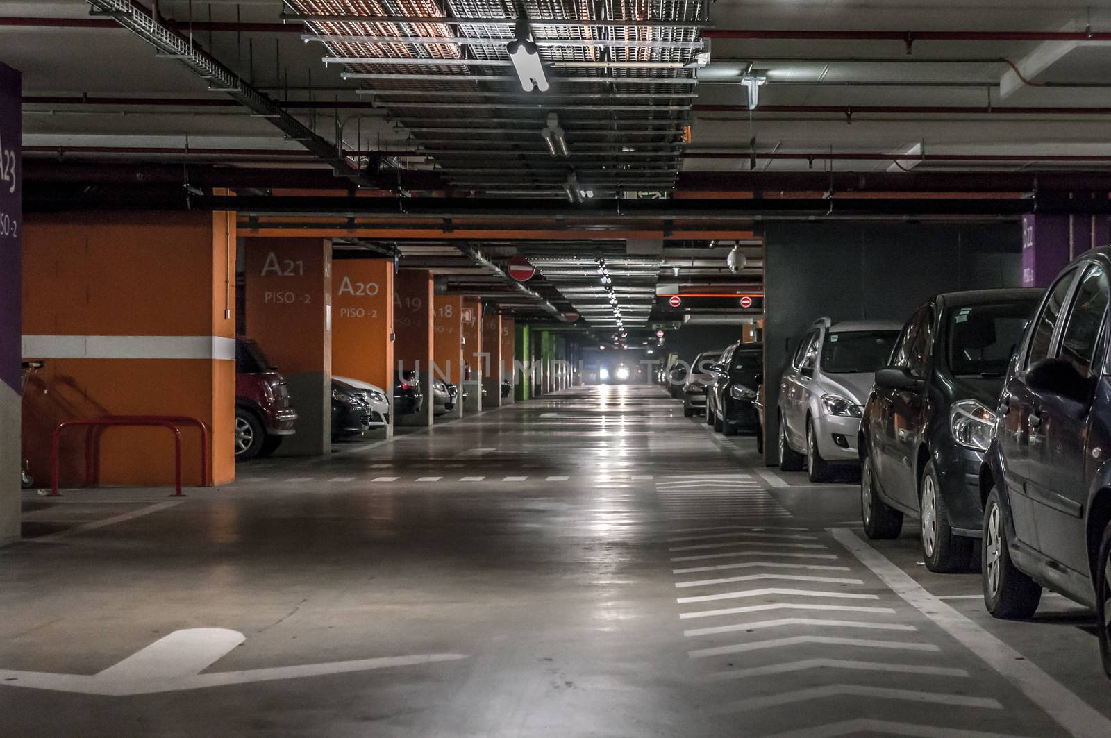 Parking garage underground, industrial interior.  Neon light in bright industrial building.