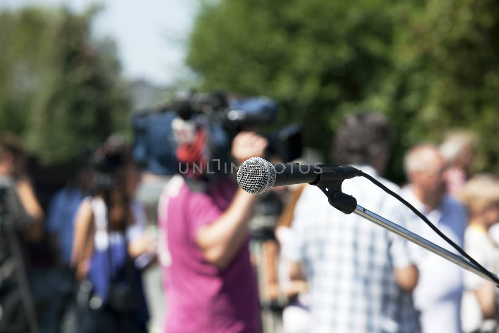 A microphone on a stage in front of audience