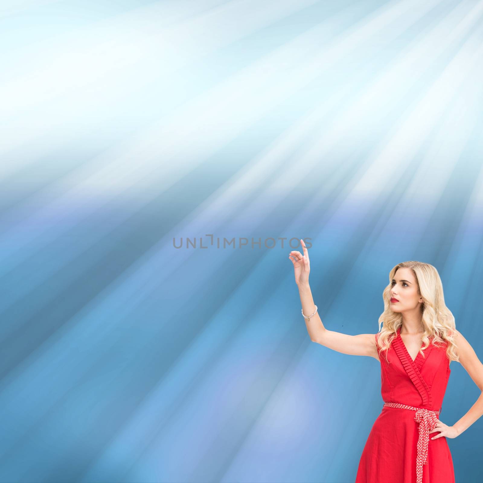 Composite image of cheerful woman in red dress pointing at something on shiny blue background