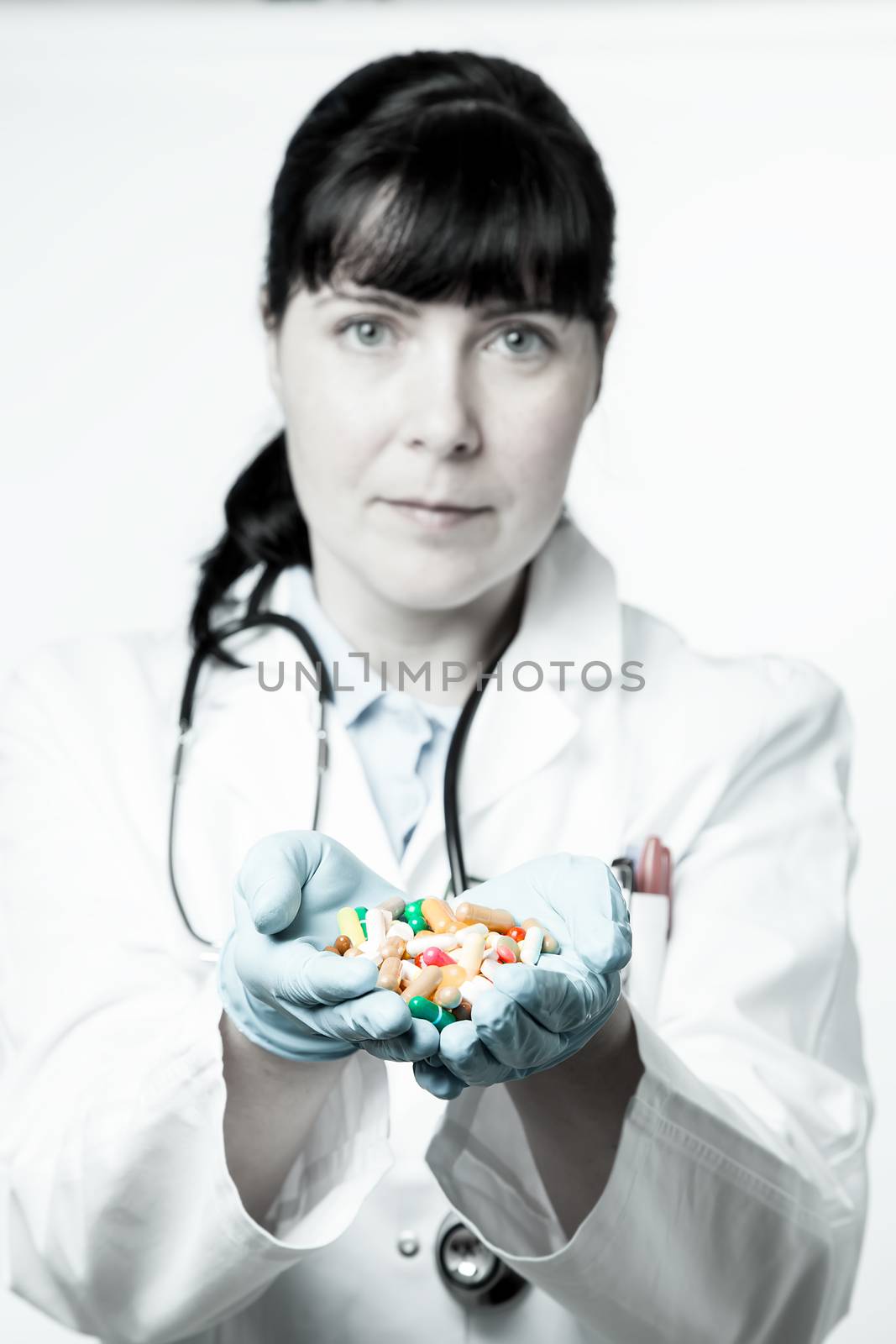 Doctor or pharmacist holding a pills in the hand