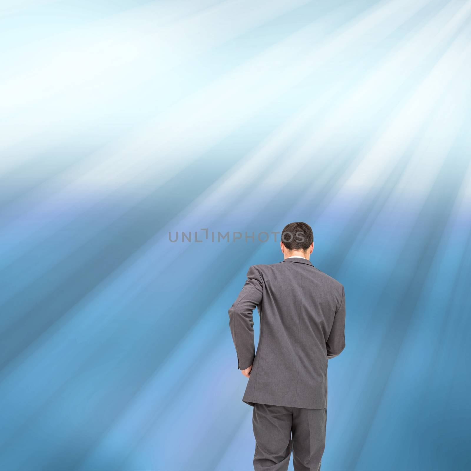 Composite image of businessman walking away on shiny blue background
