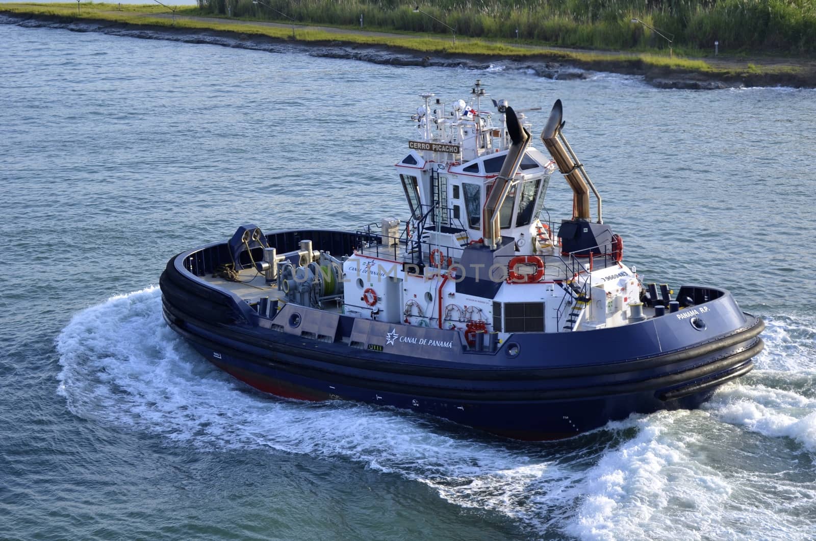 tug boat used to guide and position ships as they enter the panama canal locks on its way to escort another ship through transit.







tug boat,utility boat,panama canal,panama,transport,water,locks,gatun,