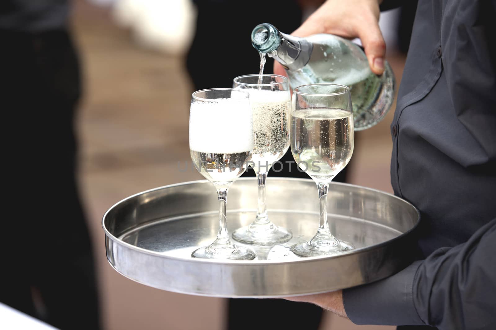 Waiter serving at a party by wellphoto