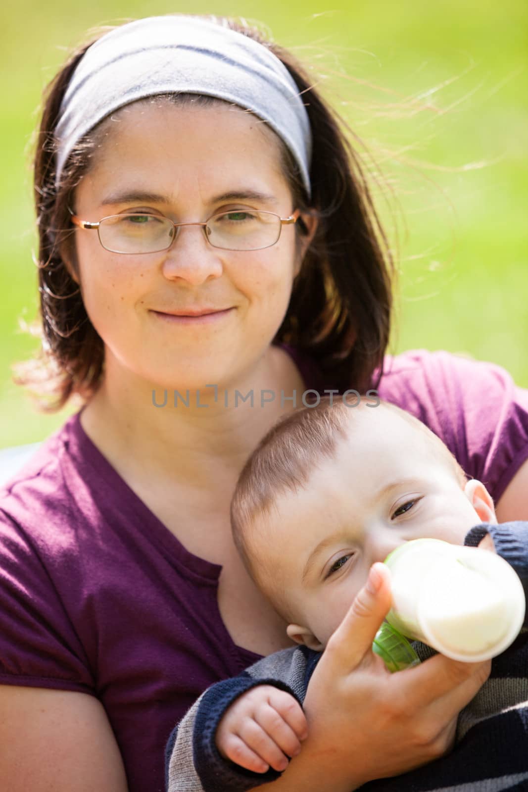 Mother feeding her baby with a milk bottle