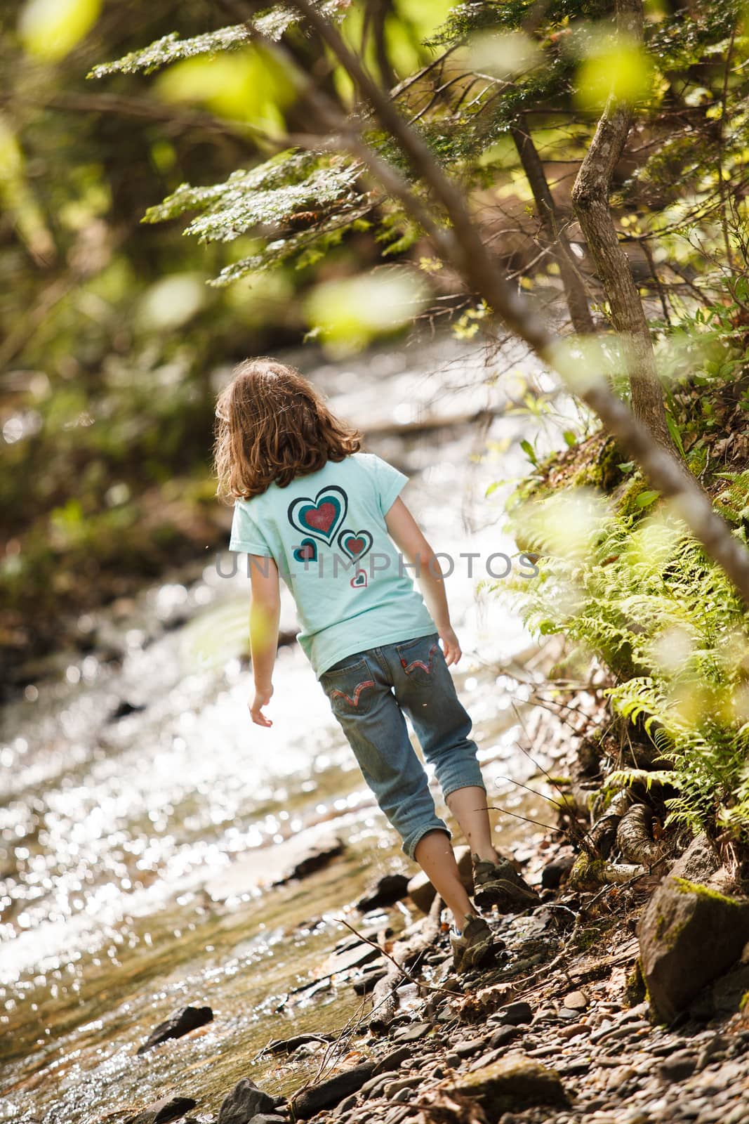 Girl playing near the river