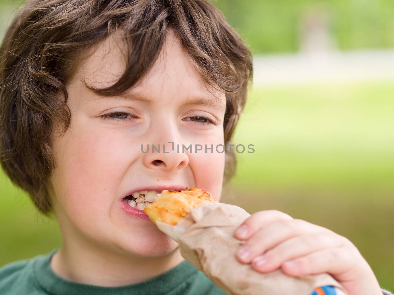 Boy eating freshly baked bread rolls