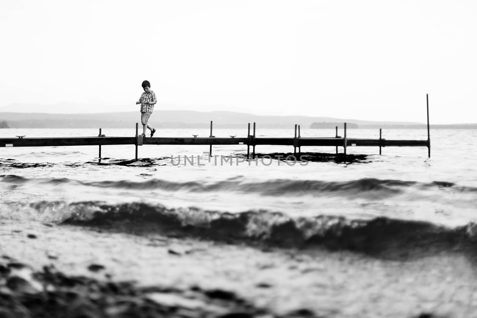 Boy walking on a wharf by Talanis
