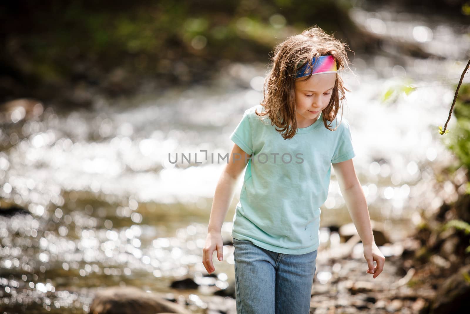 Girl playing near the river