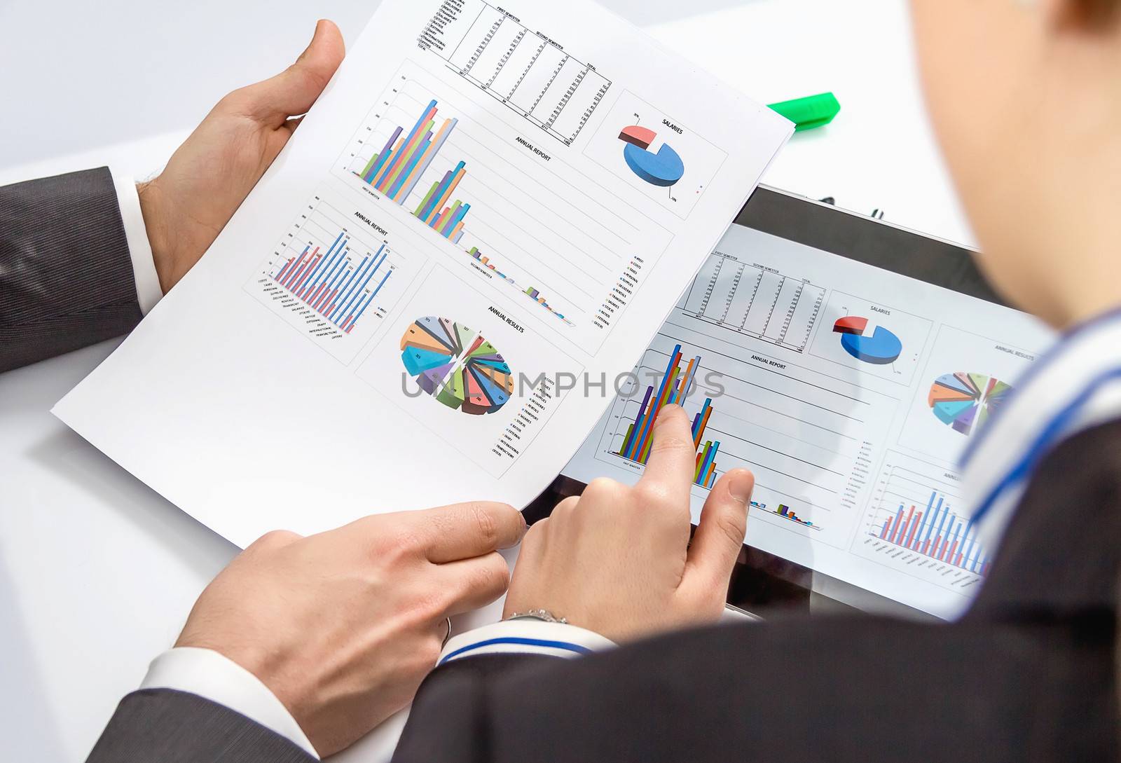 Businesswoman showing financial charts and documents in a digital tablet to the company boss