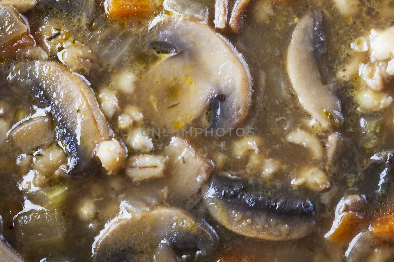 Mushroom and barley soup close up background.