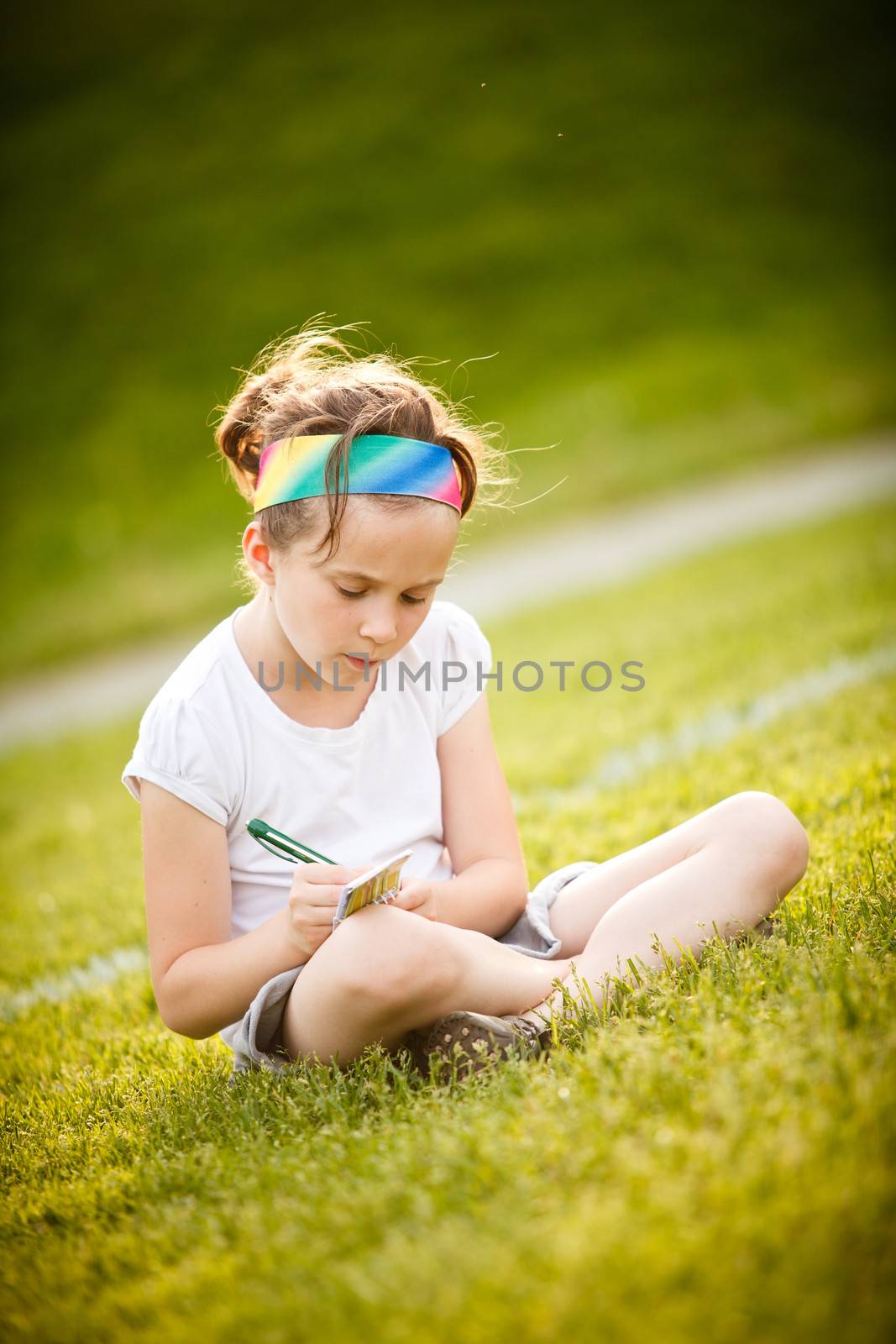 Little girl writing by Talanis