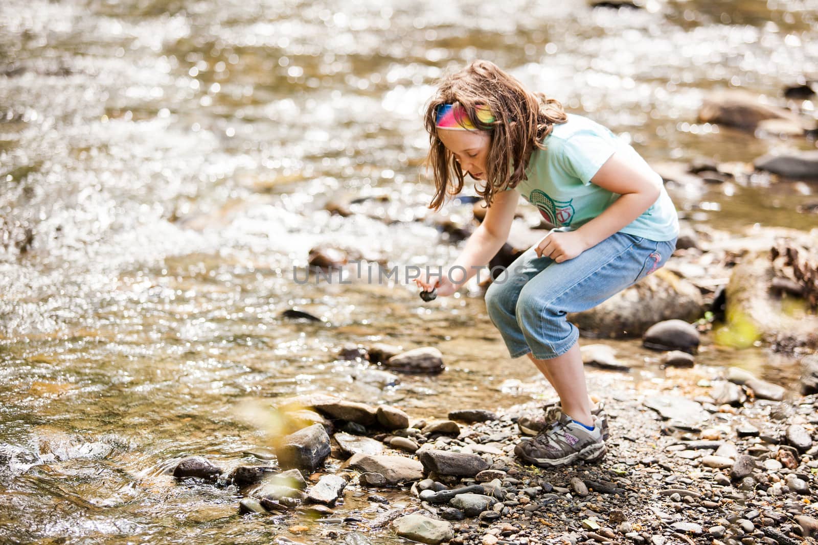 Girl playing near the river