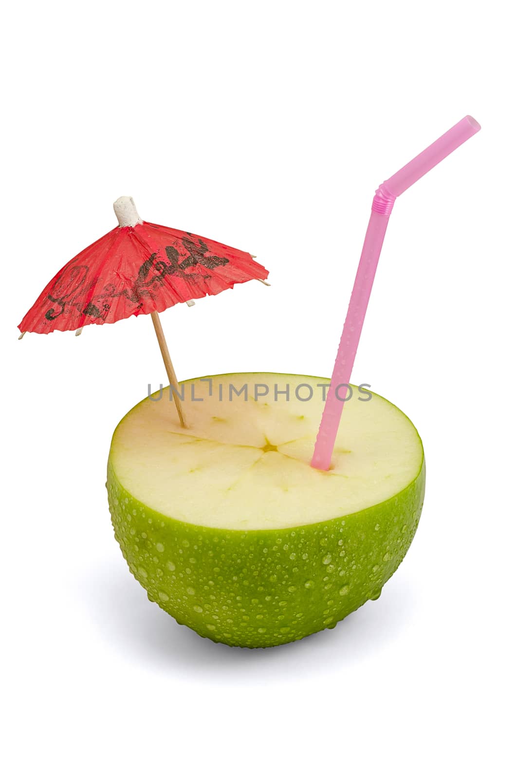 Close-up of green apple with a straw and umbrella, isolated on white