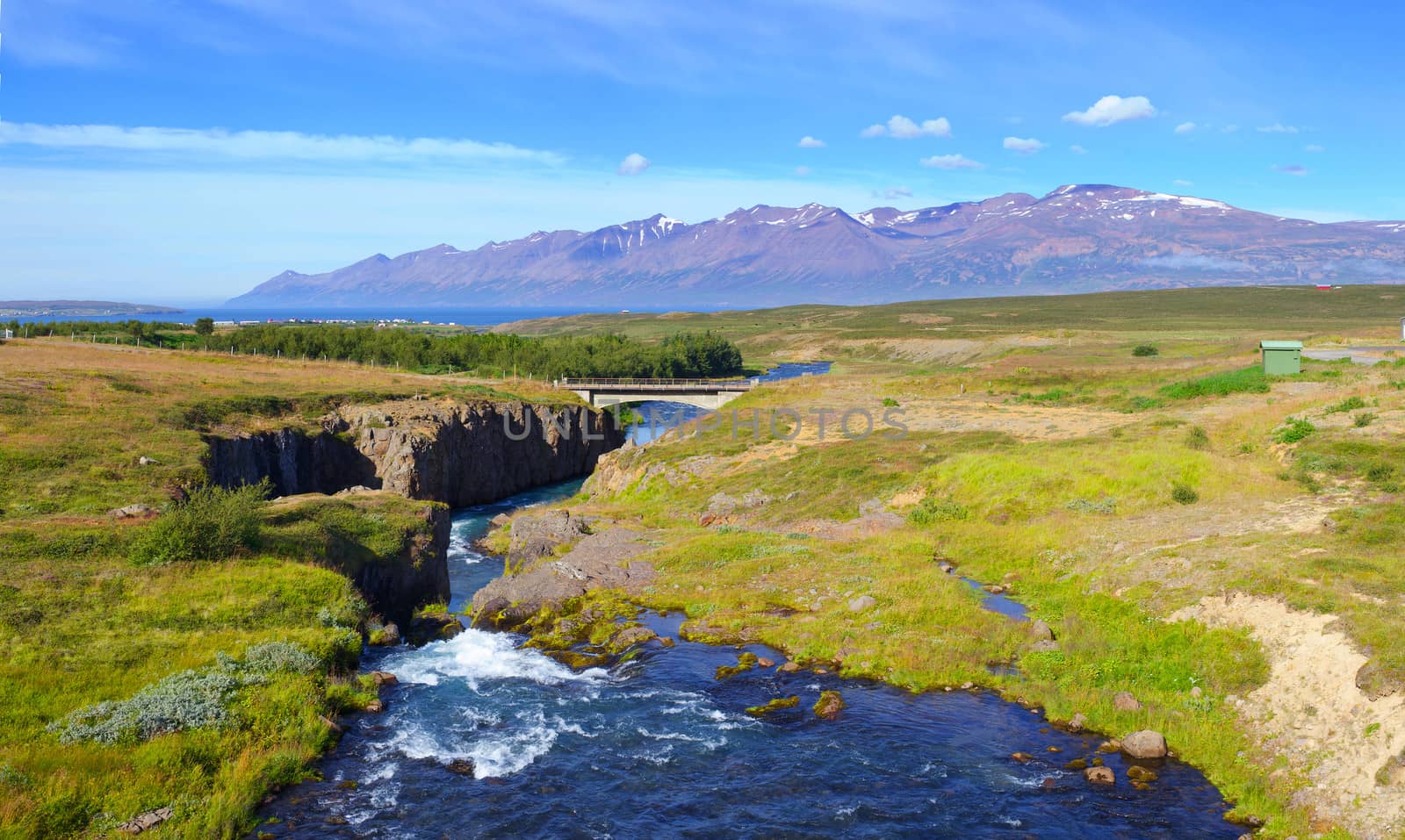 Beautiful landscape. Iceland. Mountain, river, forest, blue sky. Panorama